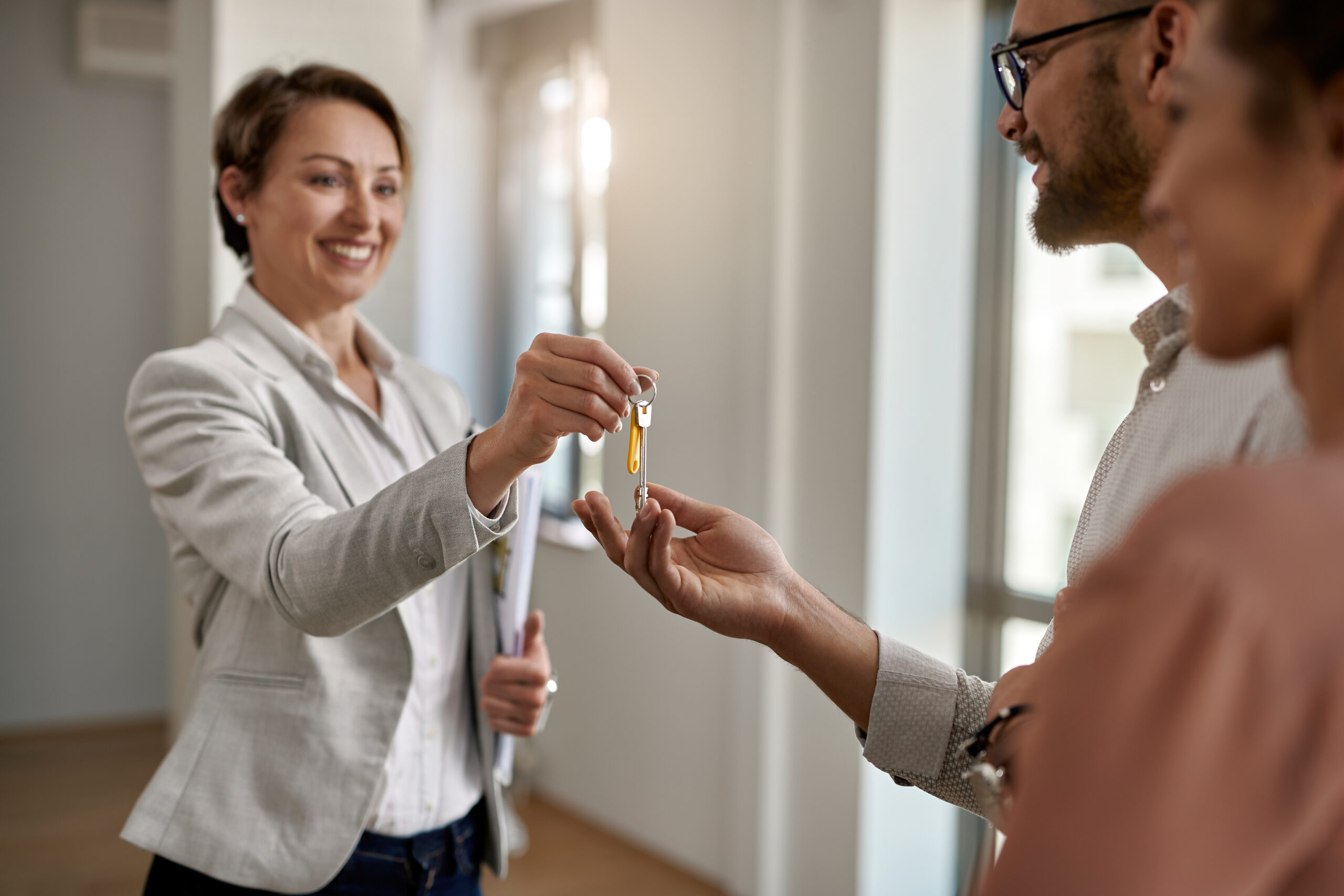A happy couple receiving the keys to their new home