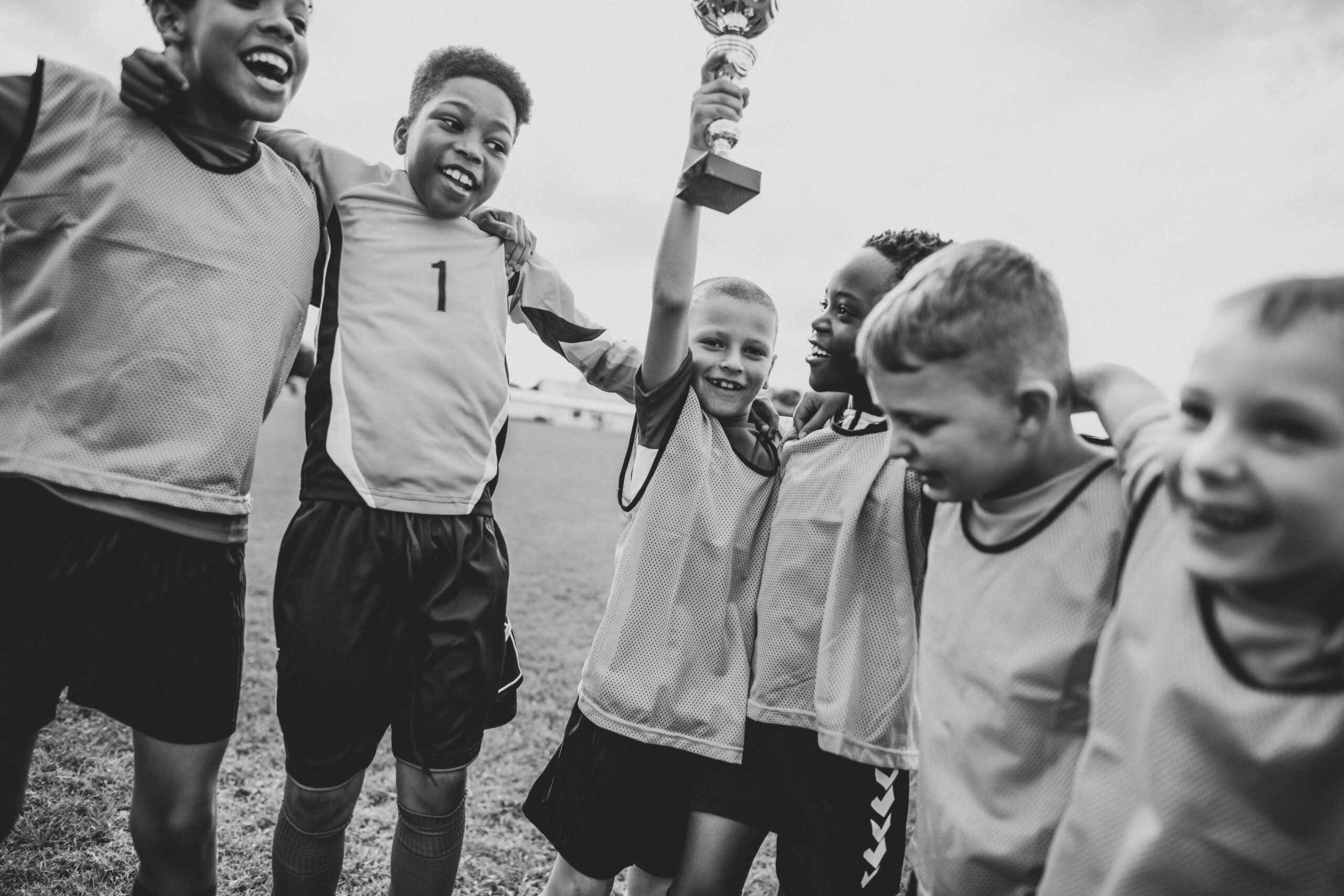 Young players celebrating a win on the field