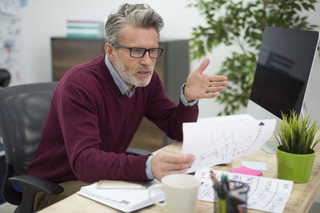 A manager frustrated by a pile of paperwork