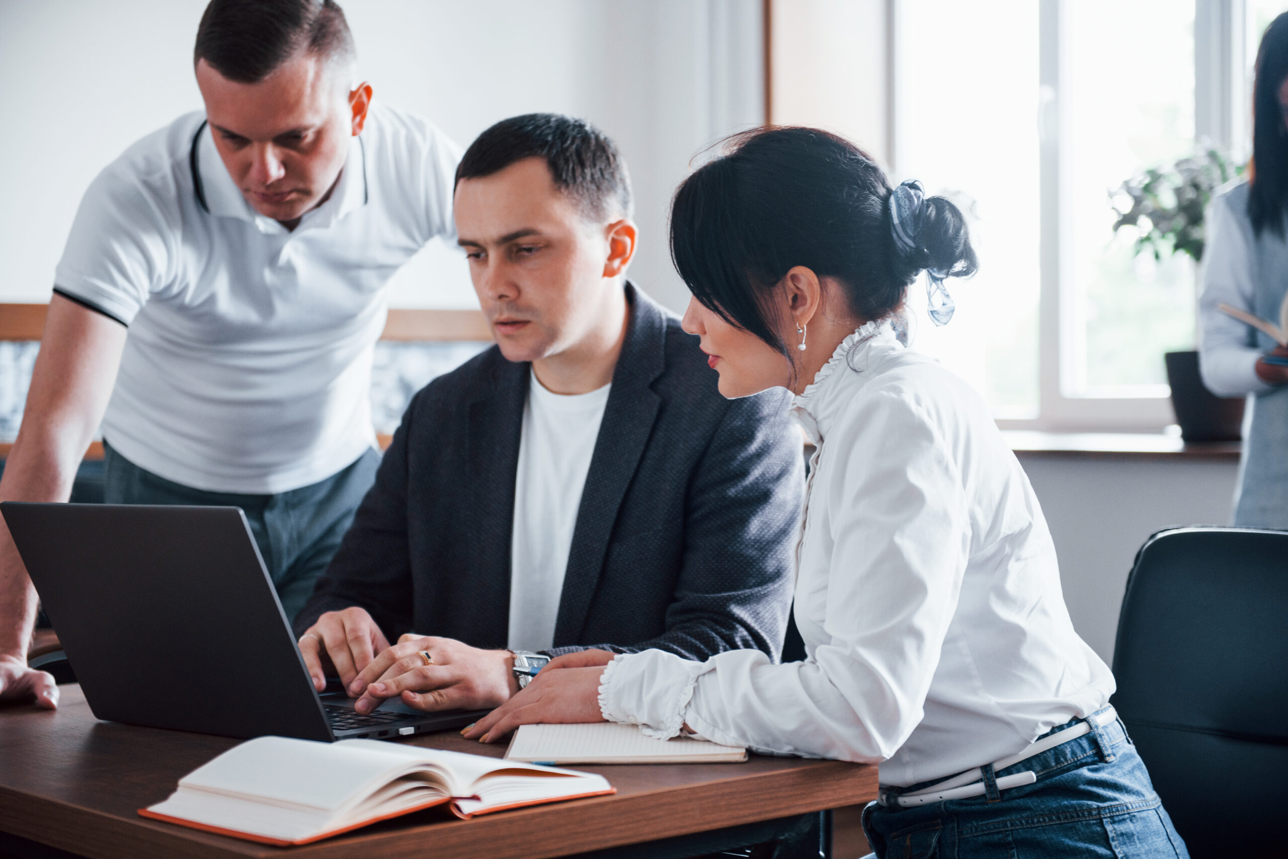A trainer guiding business professionals through a workshop session
